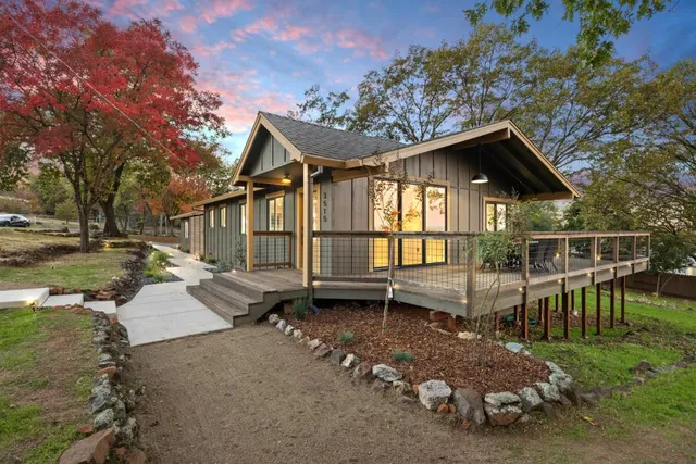 a living room with furniture and a view of kitchen
