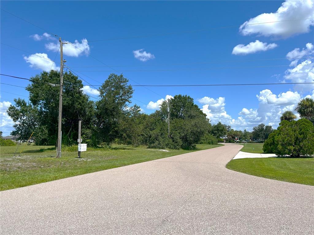 1394 Saxony Circle Punta Gorda, FL 33983 - Photo 13 of 13 a view of a golf course with a lake