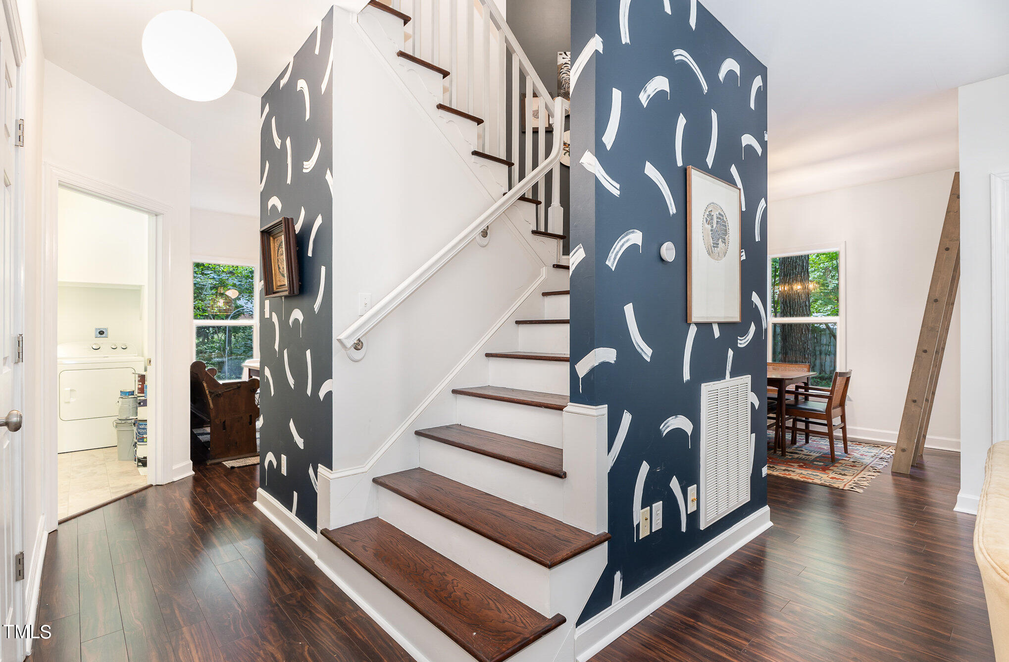 1713 Evergreen Avenue Raleigh, NC 27603 - Photo 13 of 26 a view of staircase with lots of frames on wall and a wooden floor