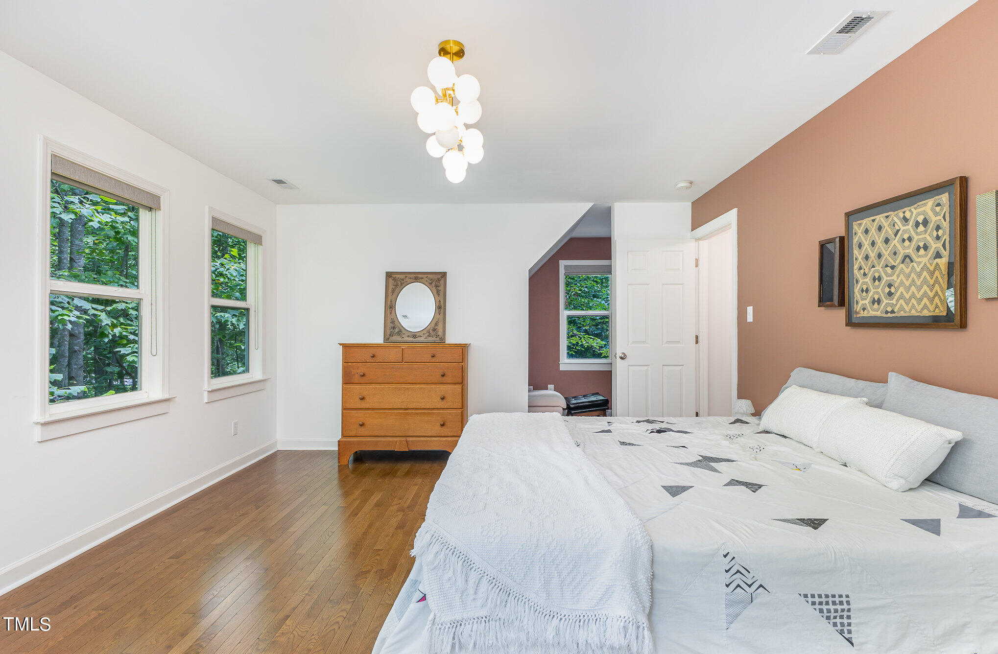 1713 Evergreen Avenue Raleigh, NC 27603 - Photo 16 of 26 a bedroom with a bed and wooden floor