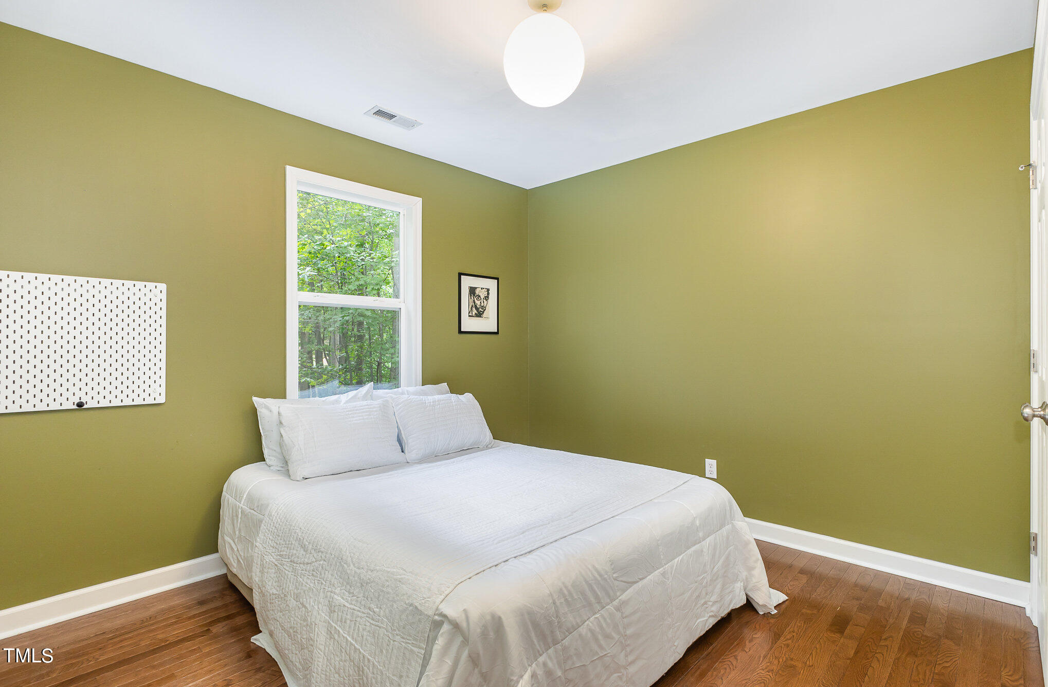 1713 Evergreen Avenue Raleigh, NC 27603 - Photo 19 of 26 a bedroom with a bed and a window