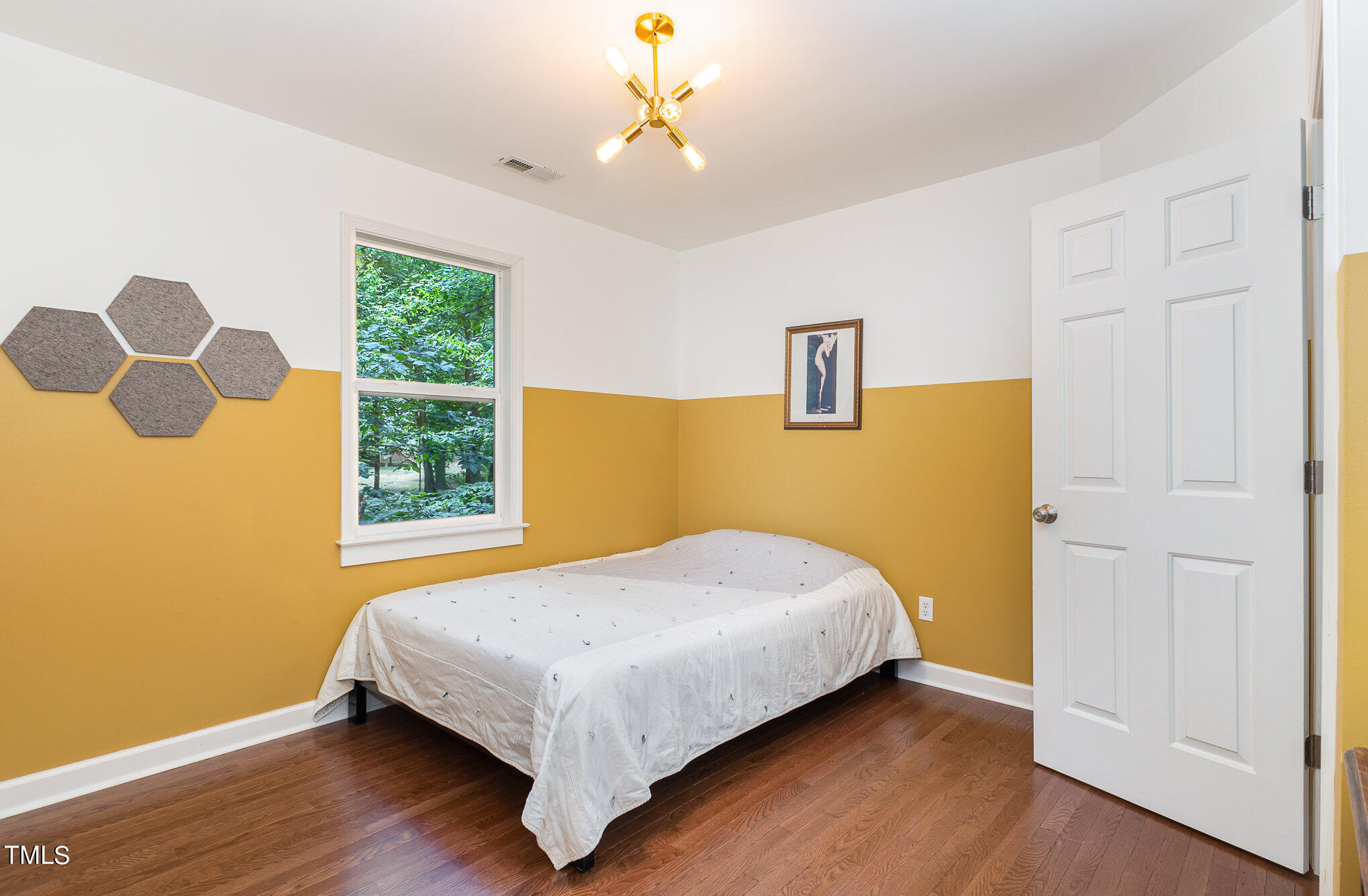 1713 Evergreen Avenue Raleigh, NC 27603 - Photo 20 of 26 a bedroom with a bed and a window