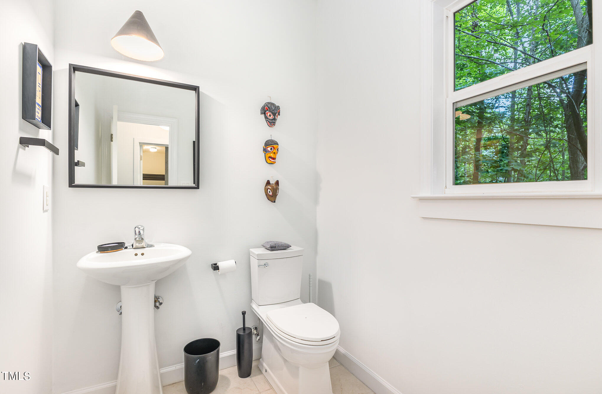 1713 Evergreen Avenue Raleigh, NC 27603 - Photo 22 of 26 a bathroom with a toilet sink and mirror