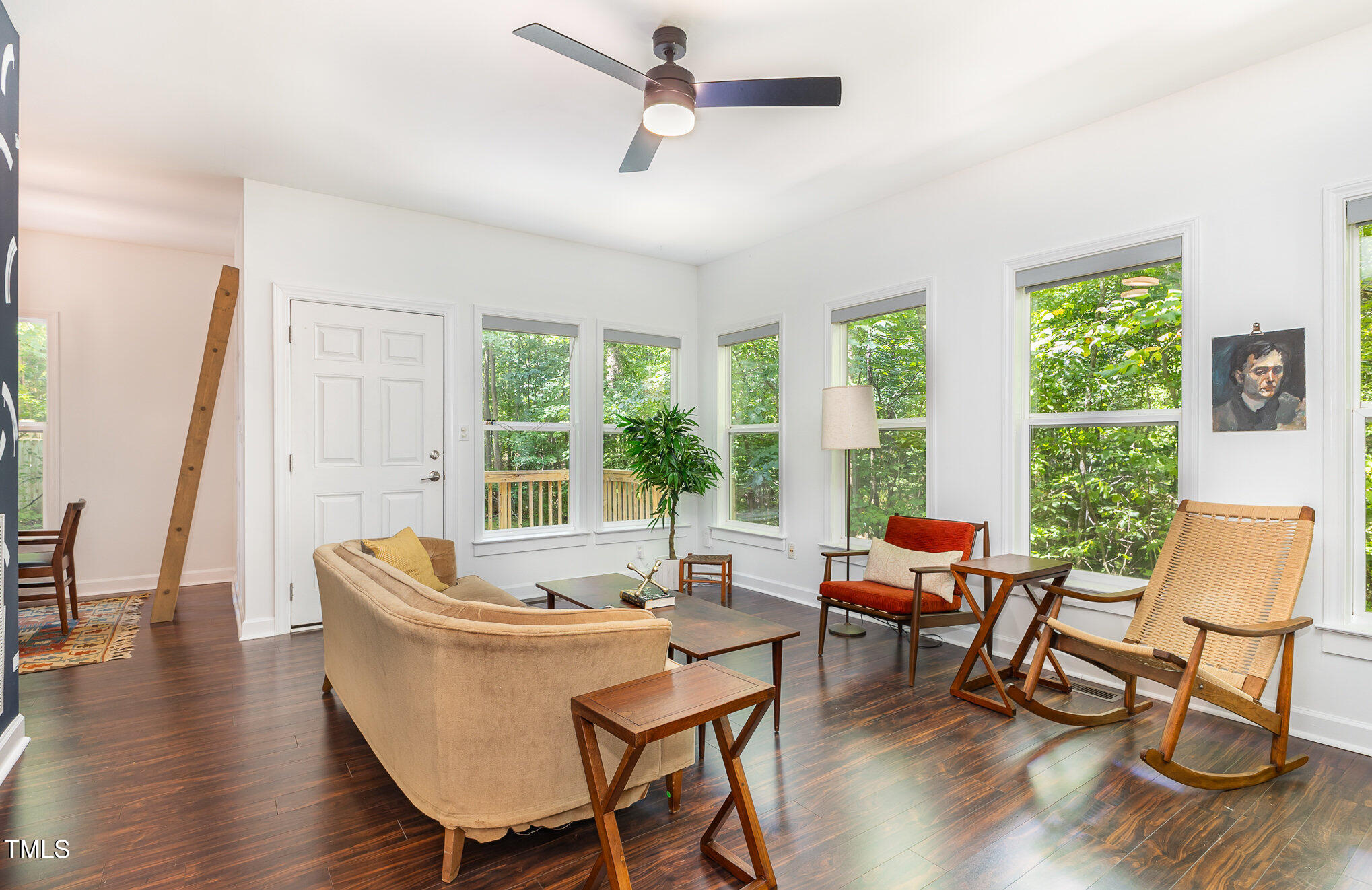 1713 Evergreen Avenue Raleigh, NC 27603 - Photo 7 of 26 a dining room with wooden floor a chandelier a glass table and chairs