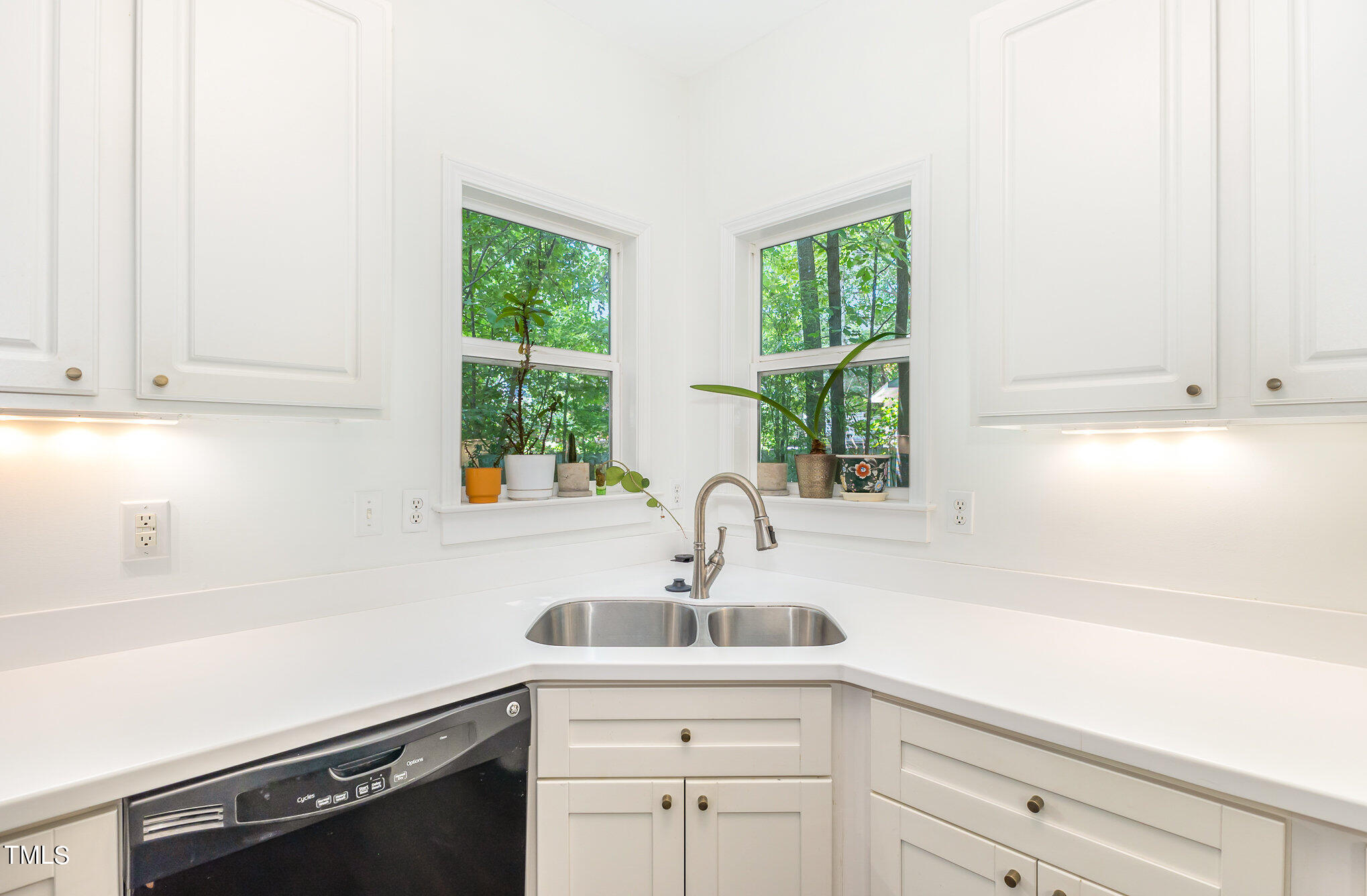1713 Evergreen Avenue Raleigh, NC 27603 - Photo 10 of 26 a kitchen with stainless steel appliances a sink a window and cabinets