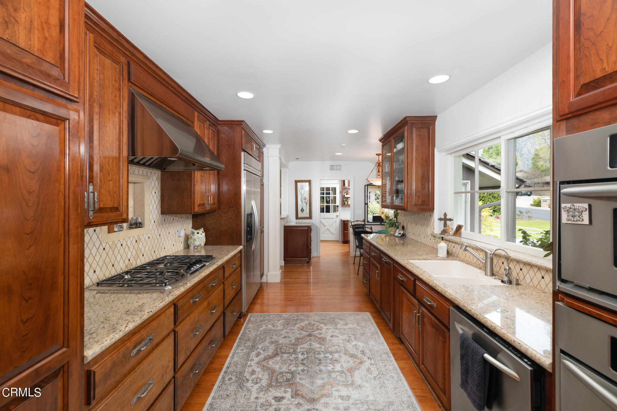1825 Elevado Avenue Arcadia, CA 91006 - Photo 30 of 63 a large kitchen with stainless steel appliances granite countertop a lot of counter space and wooden floor