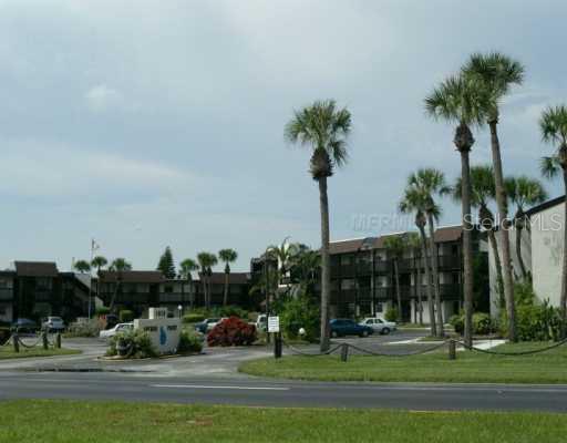 1028 Apollo Beach, Unit 312 Apollo Beach, FL 33572 - Photo 1 of 1 a front view of multi story residential apartment building with yard and green space