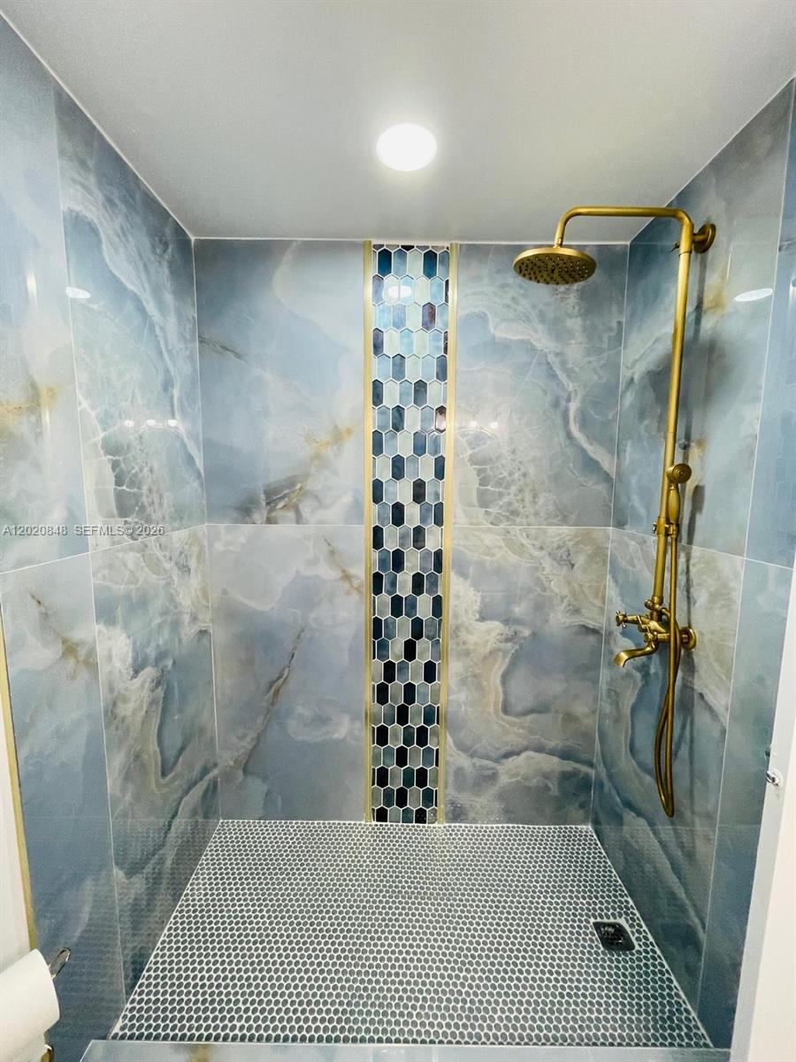 9175 Southwest 77th Avenue, Unit 306 Miami, FL 33156 - Photo 14 of 16 a bathroom with a bathtub and shower