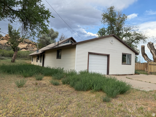 4709 East Independence Road Myton, UT 84052 - Photo 5 of 25 Single-story residence featuring light-colored siding and a brown-trimmed roofline