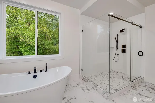 a bathroom with a bathtub and a shower