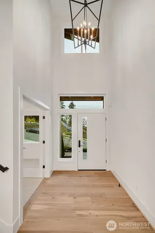 a view of a room with wooden floor and chandelier