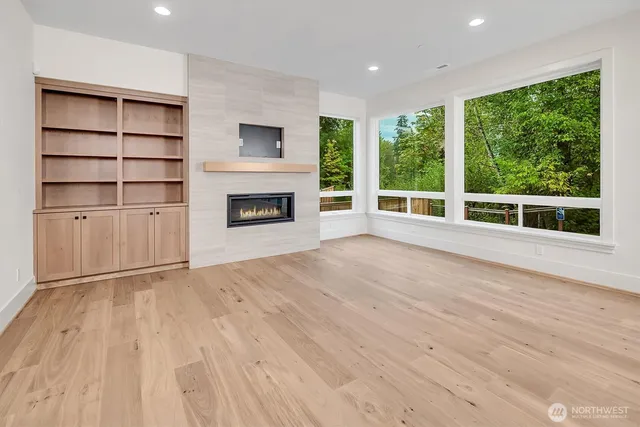 a view of an empty room with a fireplace and a window