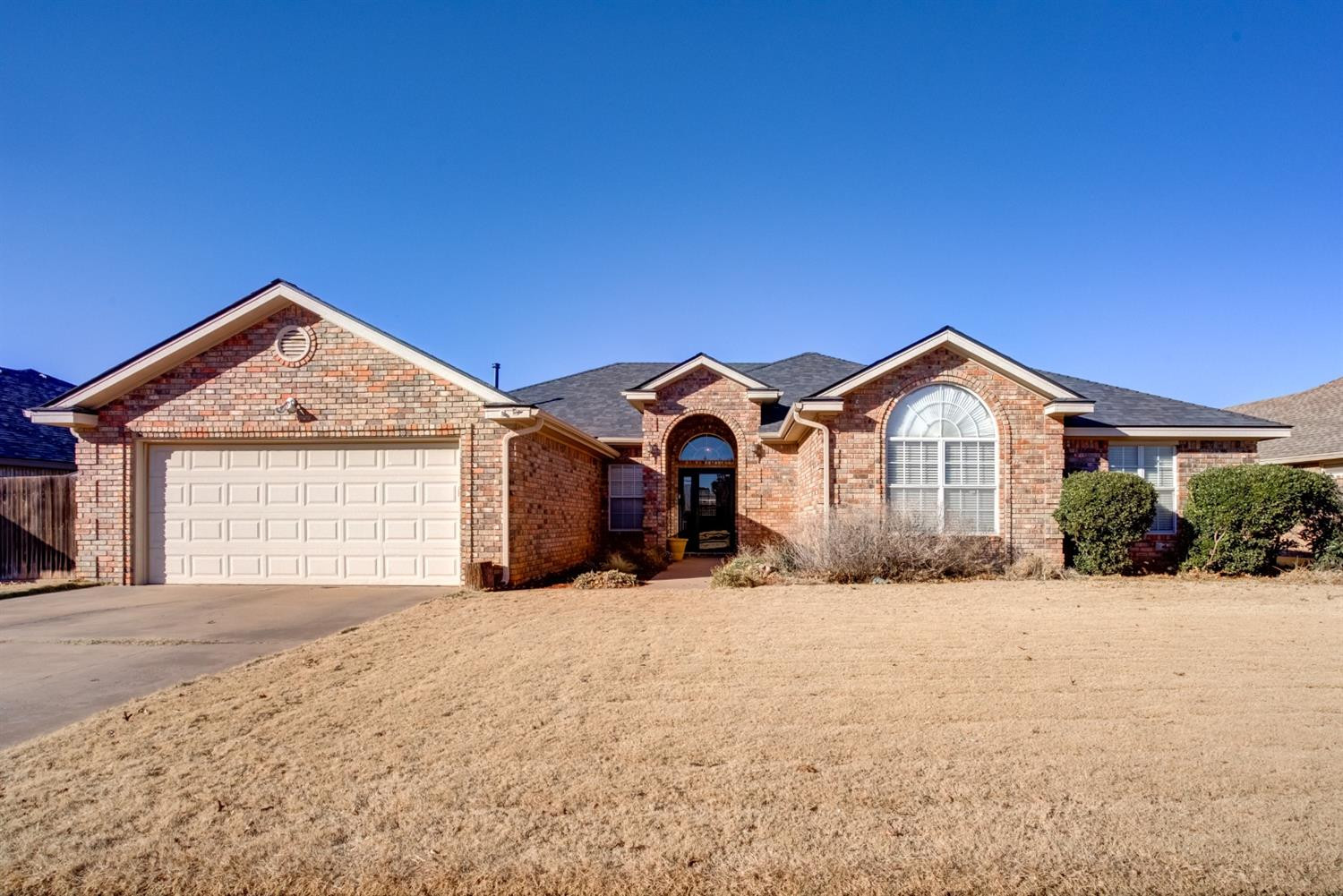 6022 78th Street Lubbock, TX 79424 - Photo 1 of 43 a front view of a house with a yard and garage