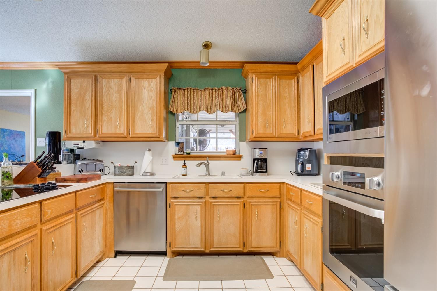 6022 78th Street Lubbock, TX 79424 - Photo 14 of 43 a kitchen with a sink window and cabinets