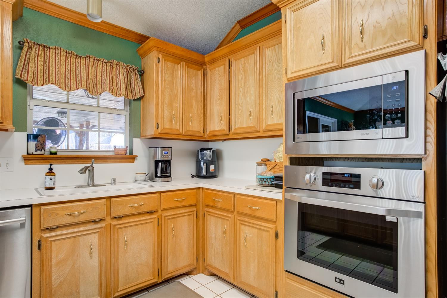 6022 78th Street Lubbock, TX 79424 - Photo 16 of 43 a kitchen with stainless steel appliances granite countertop a sink a stove and cabinets