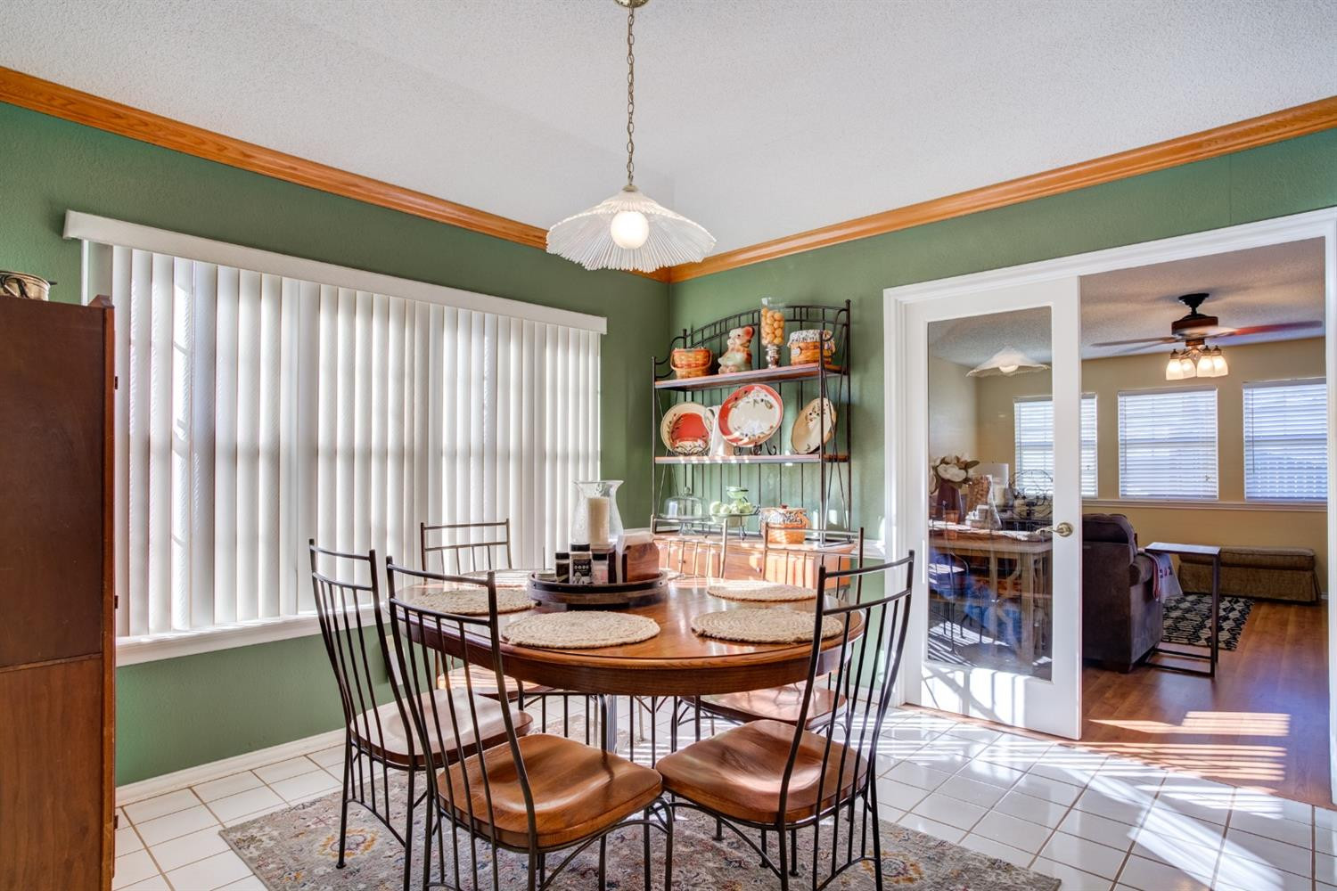 6022 78th Street Lubbock, TX 79424 - Photo 20 of 43 a dining room with furniture a rug a potted plant and a chandelier
