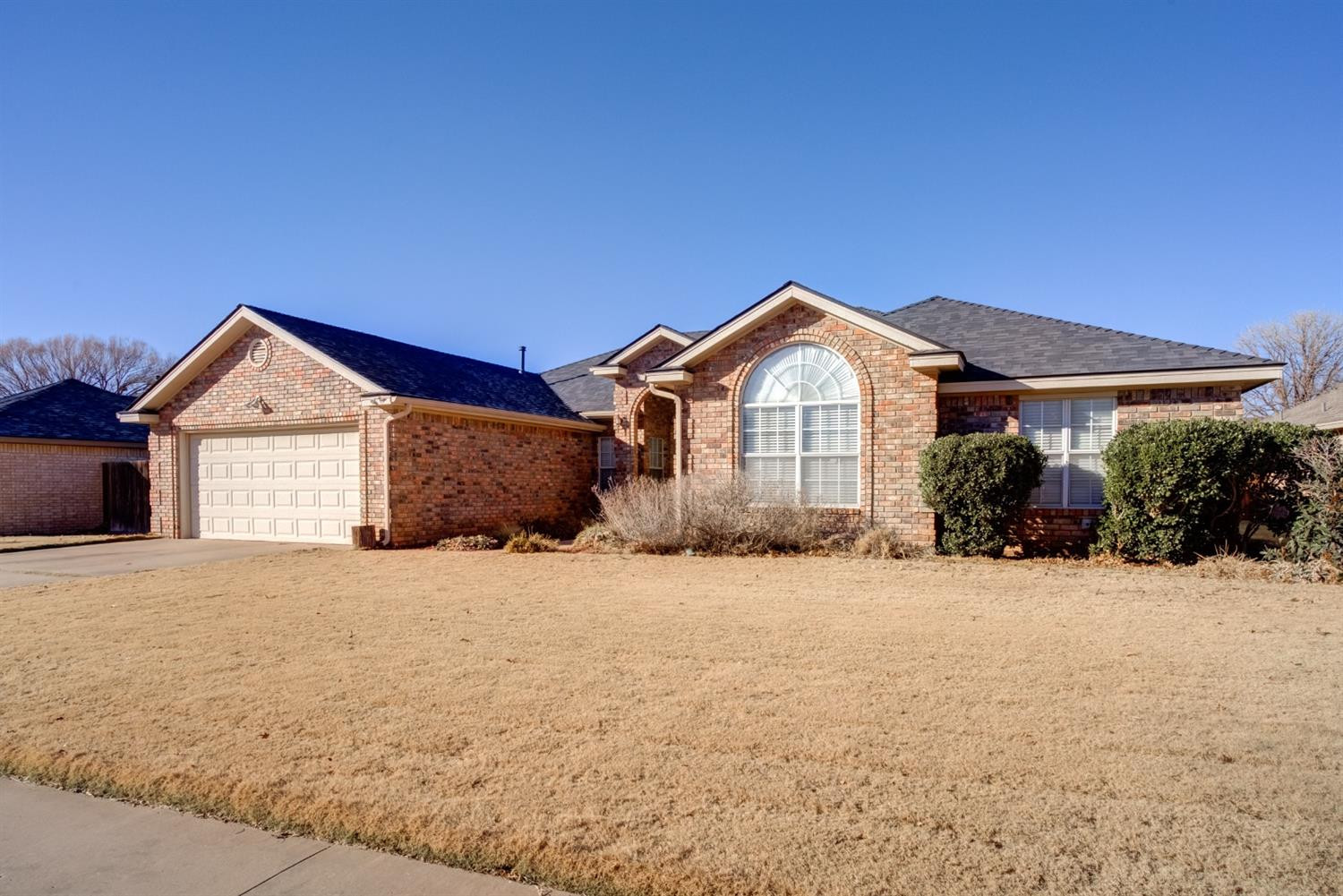 6022 78th Street Lubbock, TX 79424 - Photo 2 of 43 a front view of a house with a yard and garage