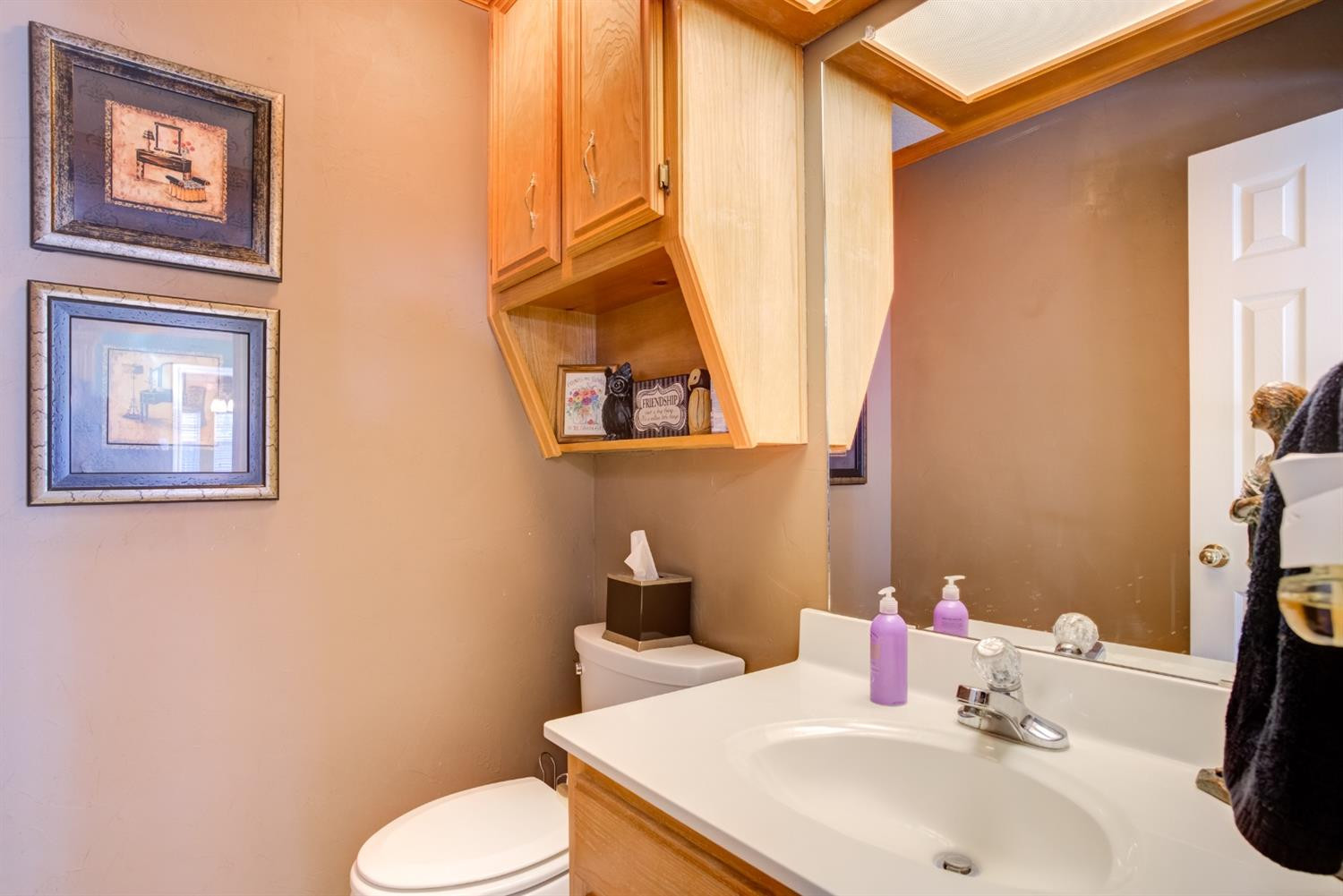 6022 78th Street Lubbock, TX 79424 - Photo 21 of 43 a bathroom with a sink mirror and toilet