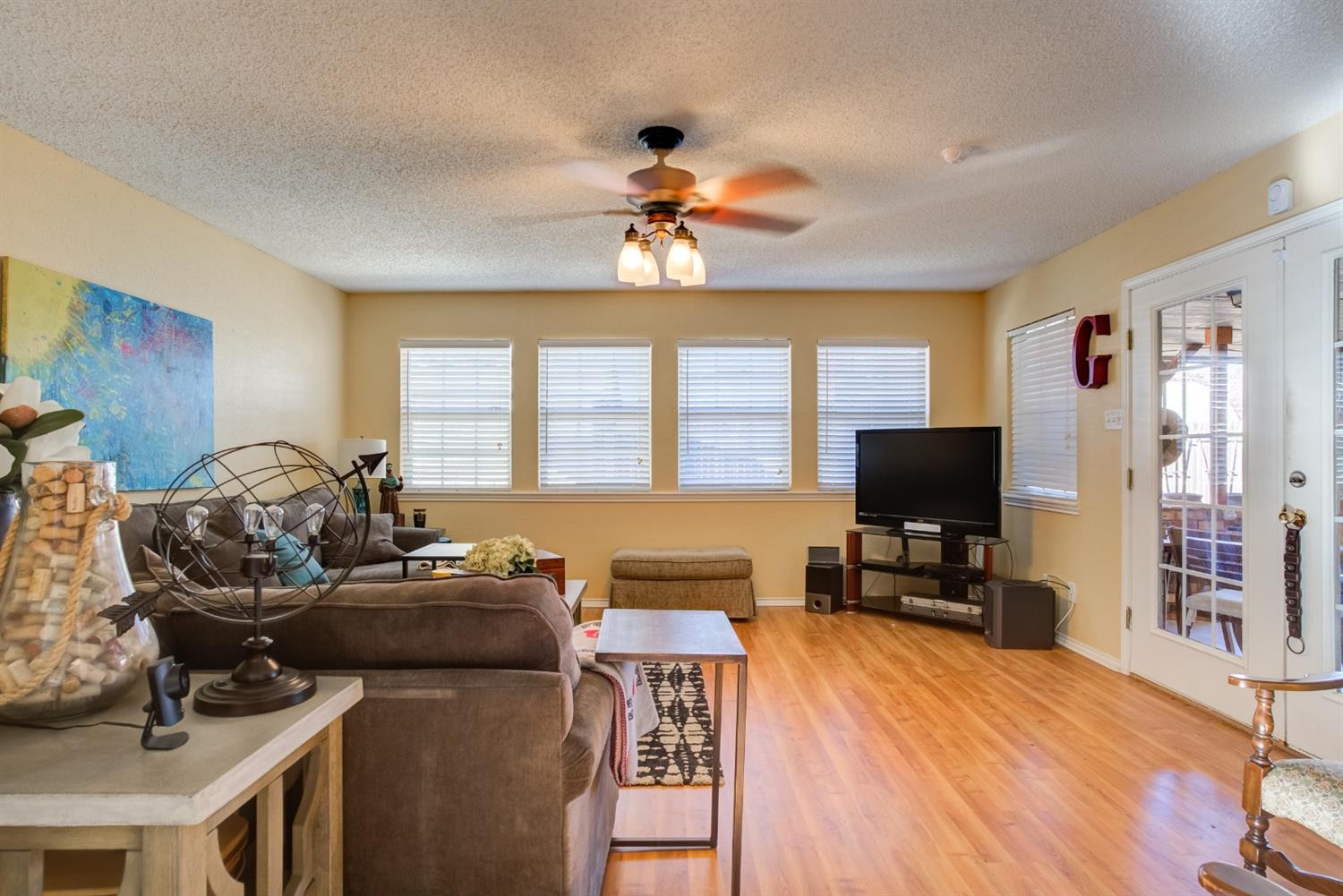 6022 78th Street Lubbock, TX 79424 - Photo 22 of 43 a living room with furniture a flat screen tv and a large window
