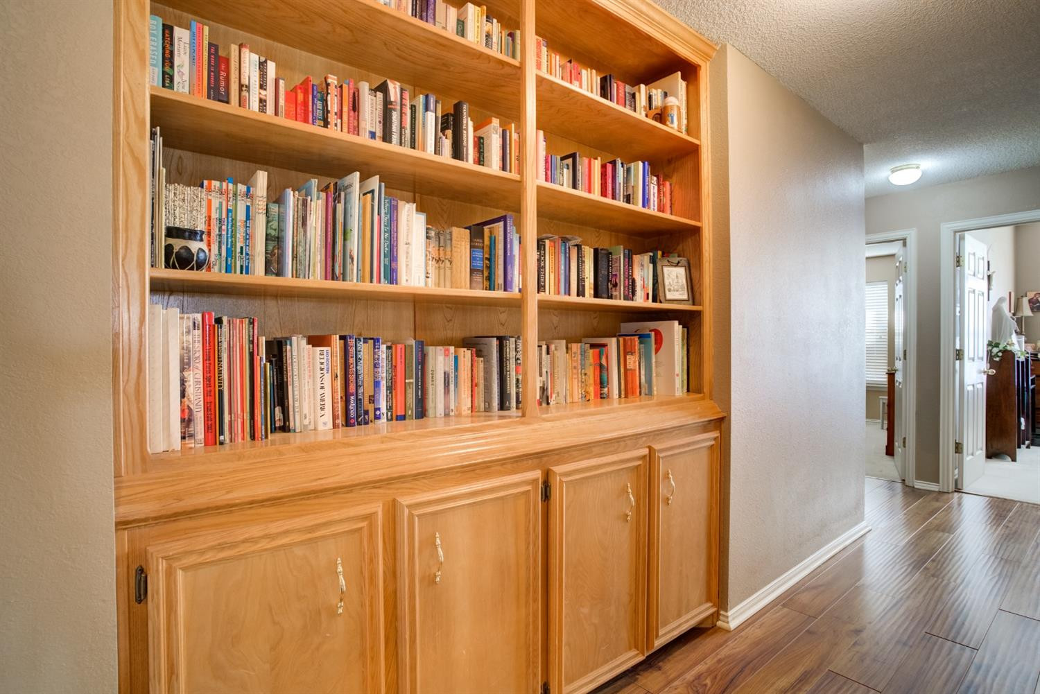 6022 78th Street Lubbock, TX 79424 - Photo 28 of 43 a view of a book shelf with a wooden floor
