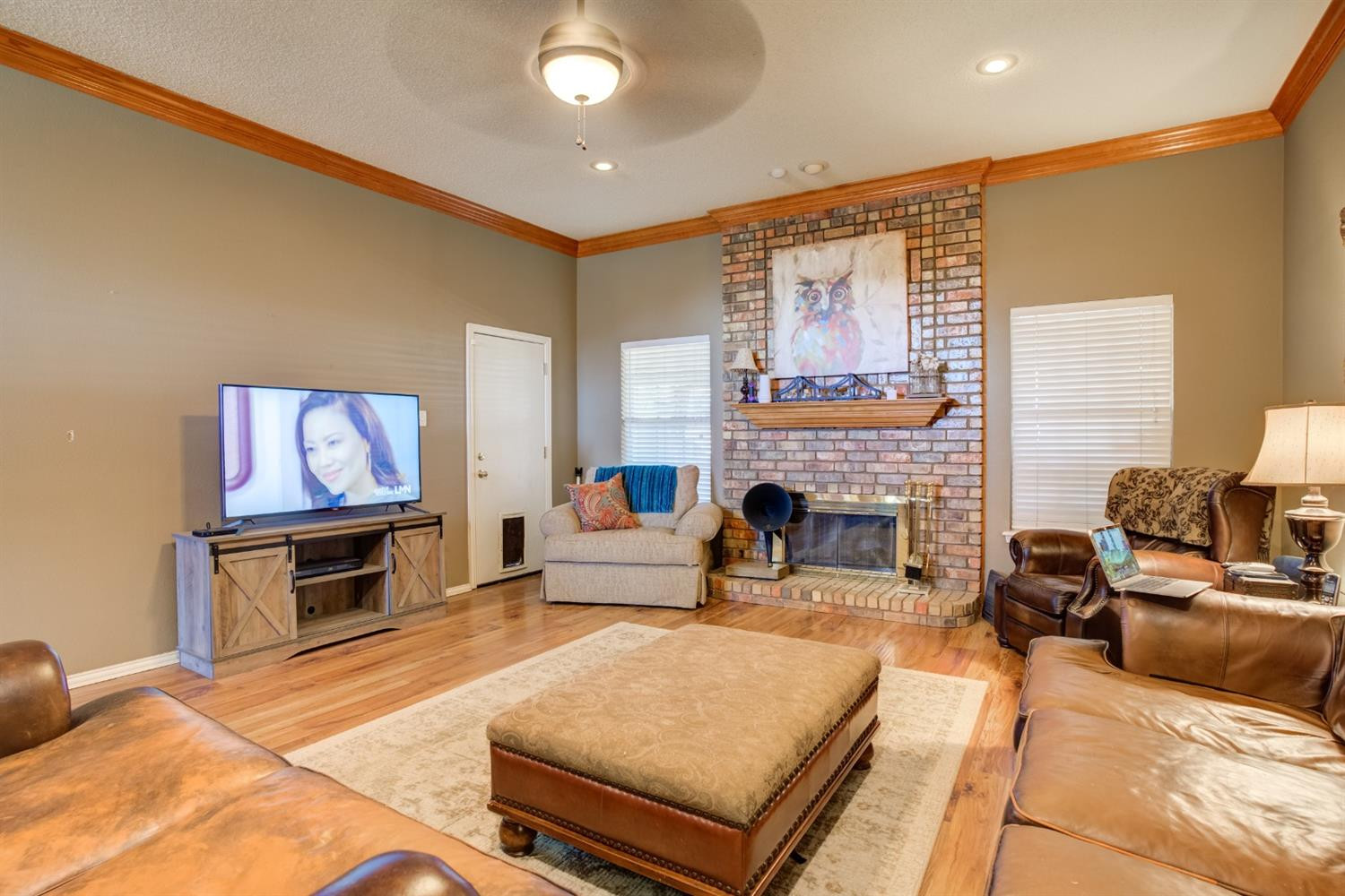 6022 78th Street Lubbock, TX 79424 - Photo 3 of 43 a living room with furniture and a fireplace