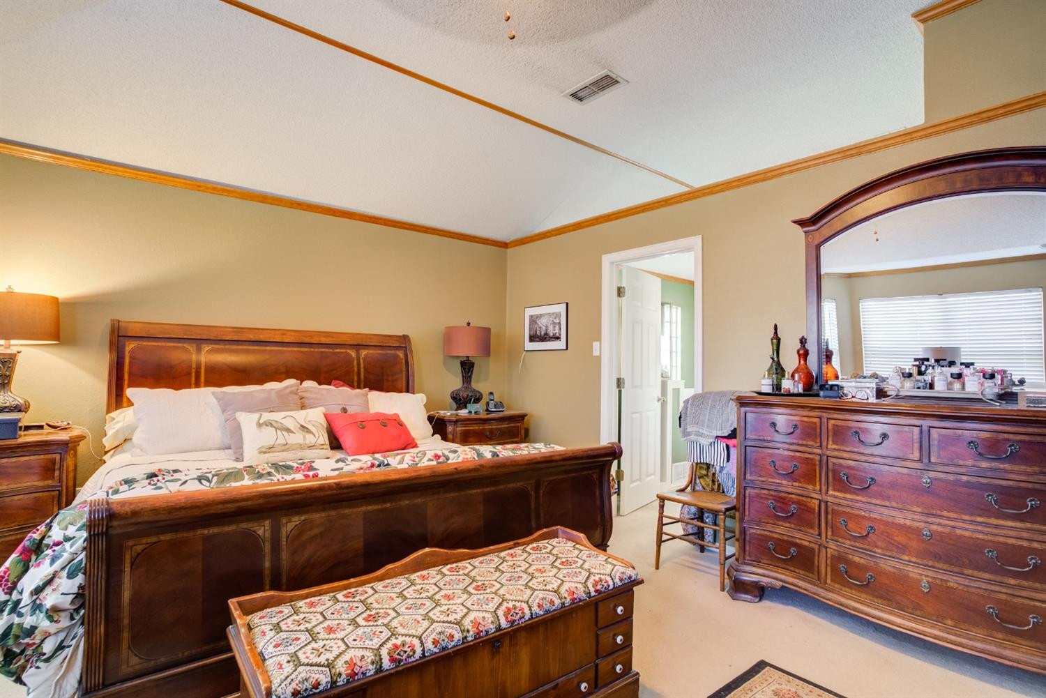 6022 78th Street Lubbock, TX 79424 - Photo 31 of 43 a bedroom with a bed and a dresser in it