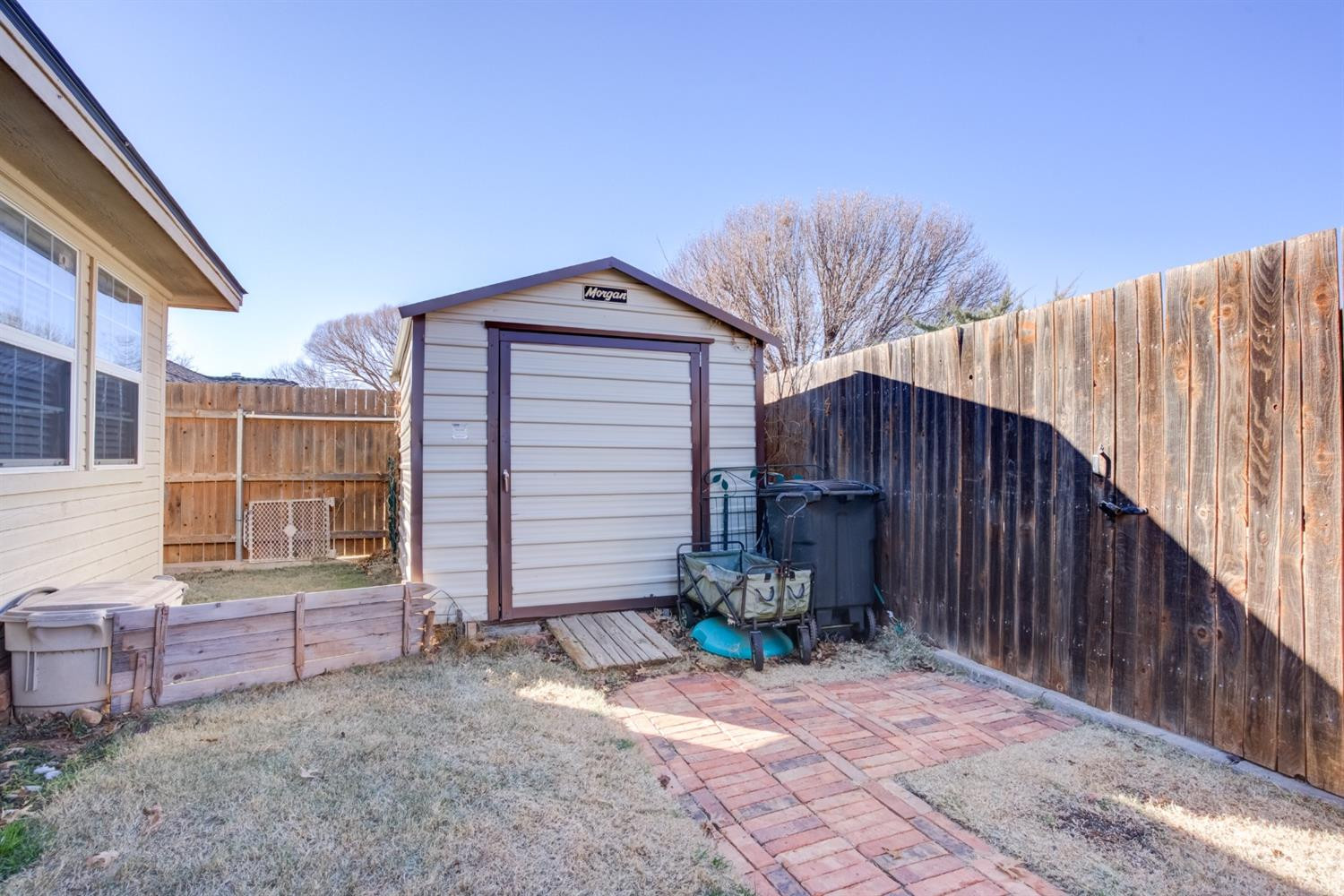 6022 78th Street Lubbock, TX 79424 - Photo 40 of 43 a view of backyard with barbeque grill and wooden fence