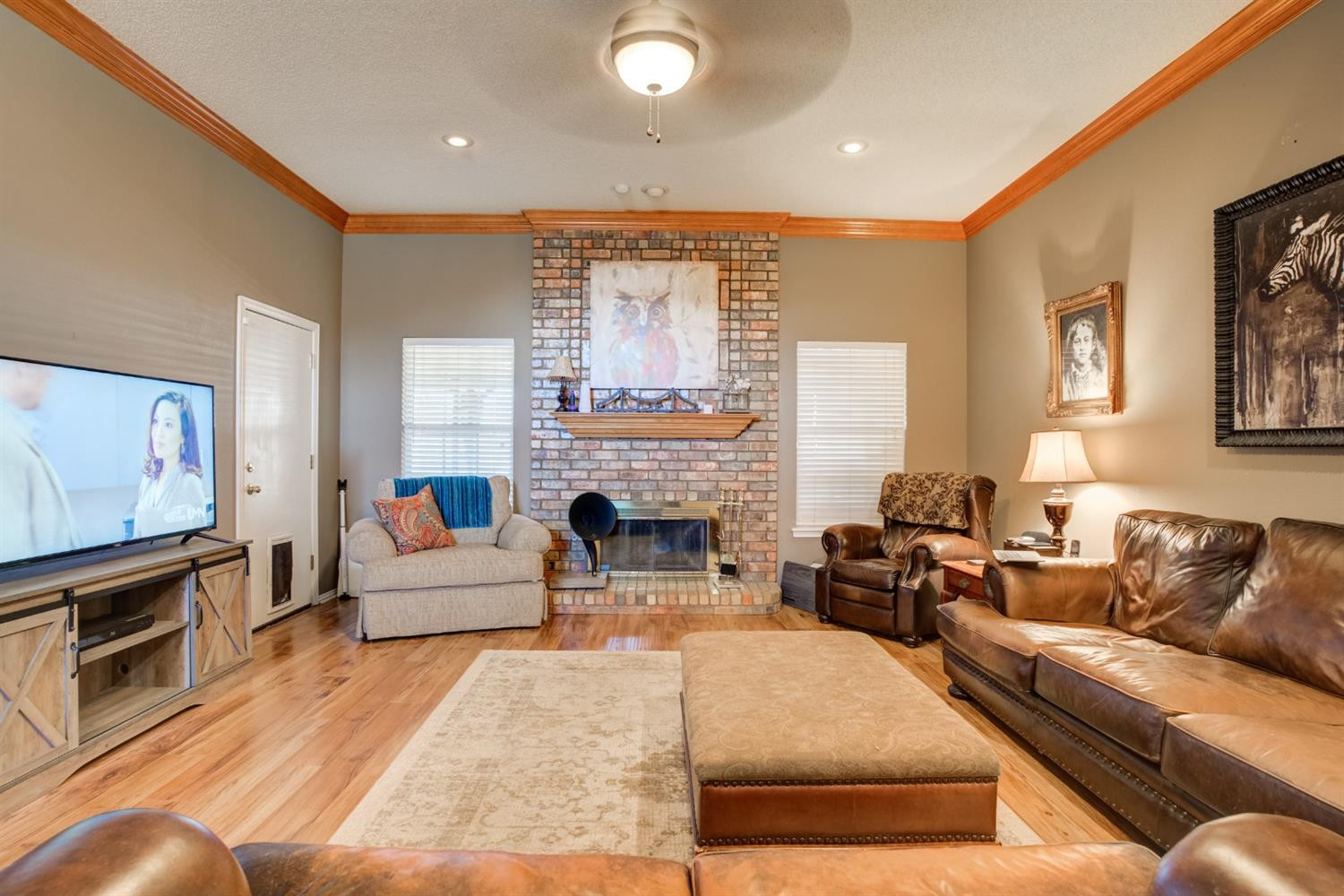 6022 78th Street Lubbock, TX 79424 - Photo 9 of 43 a living room with furniture a fireplace and a flat screen tv