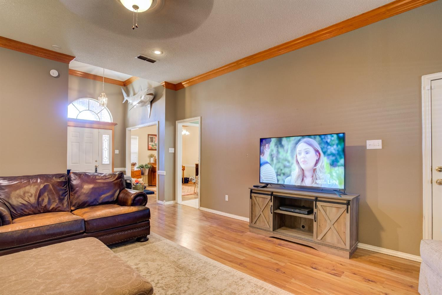 6022 78th Street Lubbock, TX 79424 - Photo 10 of 43 a living room with furniture and a flat screen tv