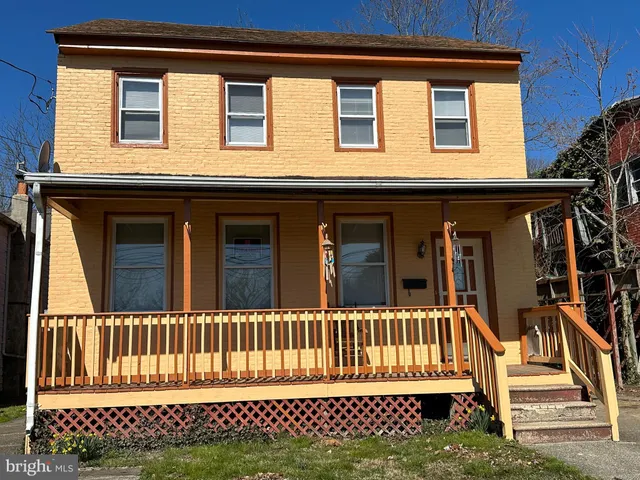a view of a house with wooden fence
