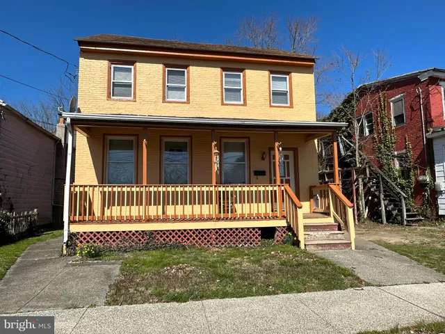 a balcony with wooden floor and outdoor seating
