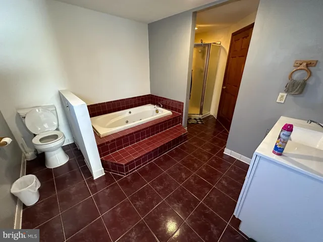 a view of backyard with wooden fence and a large tree