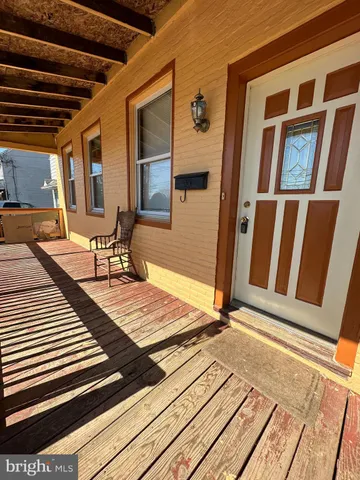 a view of a room with wooden floor and furniture