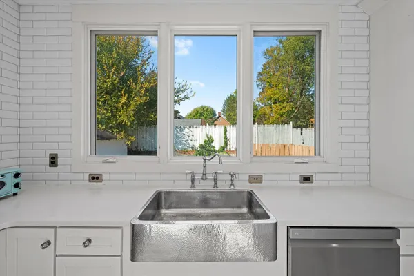 a kitchen with a sink and large window