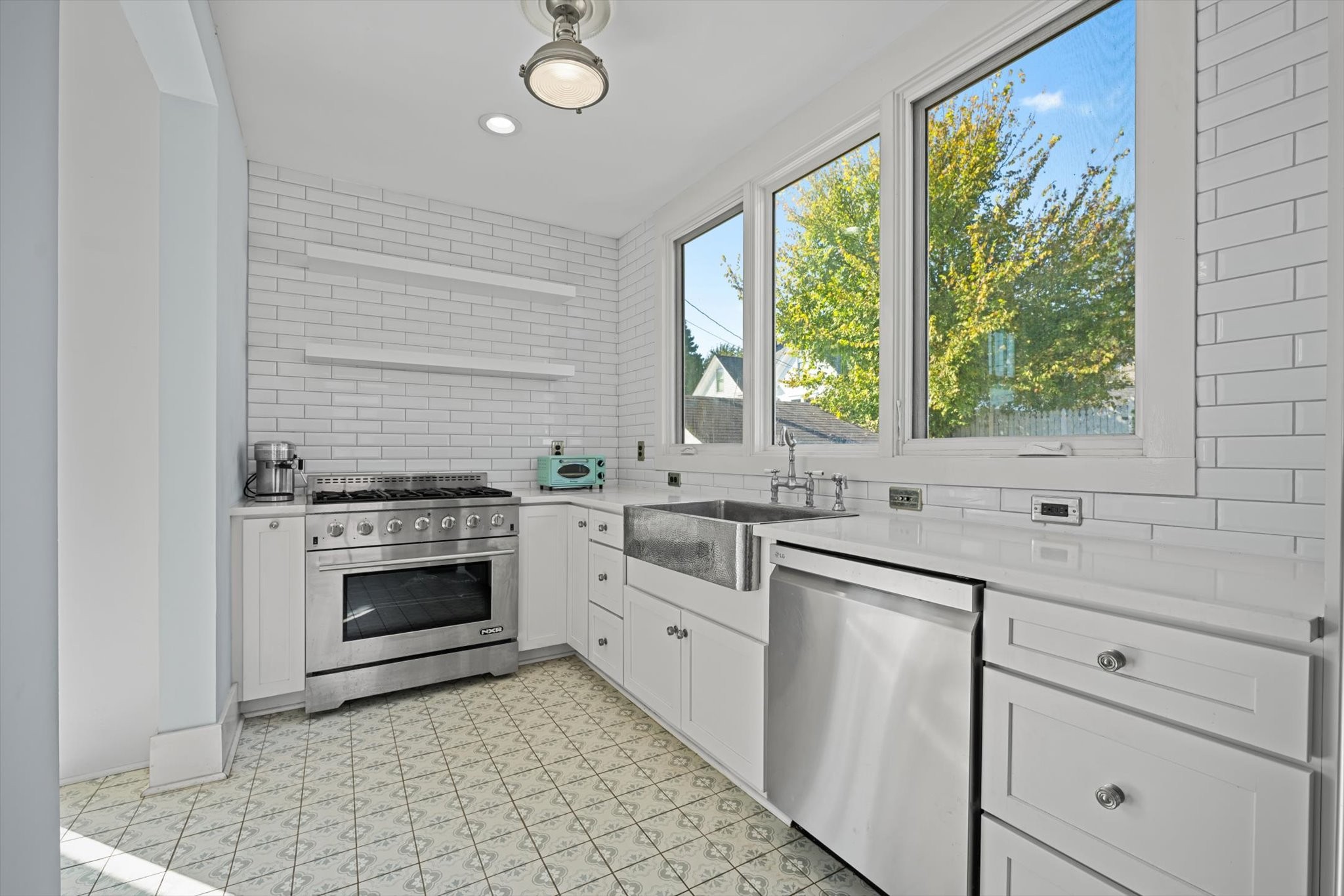 409 North Oak Street Springfield, TN 37172 - Photo 12 of 32 a kitchen with white cabinets and appliances