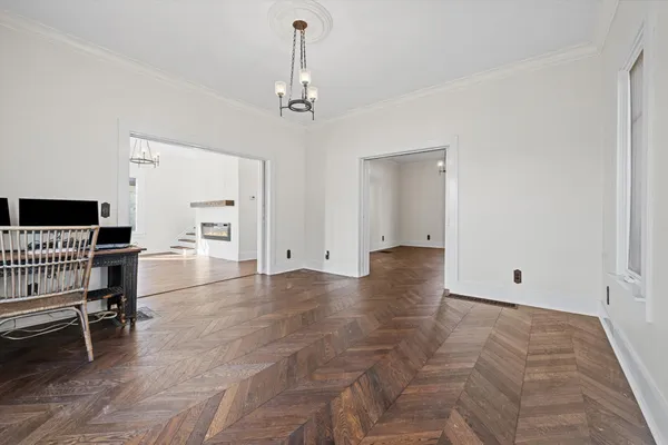 a view of empty room with wooden floor