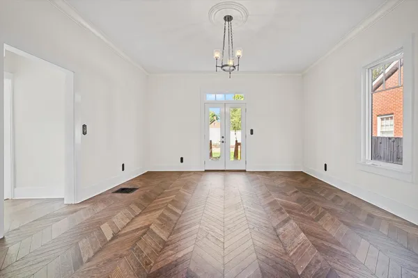 a view of a room with a window and wooden floor
