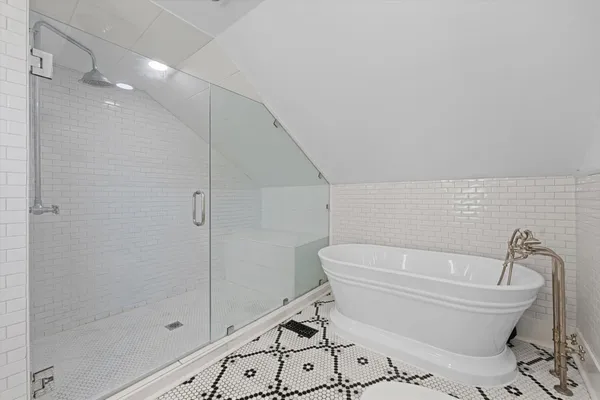 a bathroom with a bathtub and shower