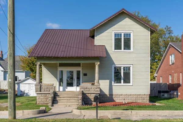 a front view of a house with a yard