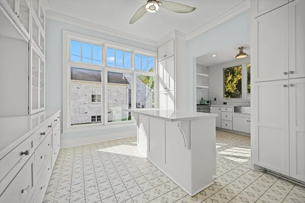 a bathroom with a double vanity sink a mirror a bathtub and next to a window