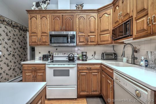 161 Jockey Hollow Road Monroe, CT 06468 - Photo 12 of 37 a kitchen with stainless steel appliances granite countertop a sink and a stove
