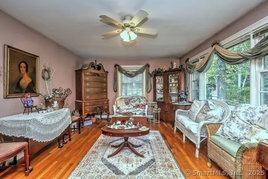a living room with patio furniture and a large window