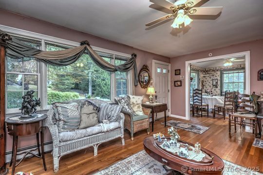 161 Jockey Hollow Road Monroe, CT 06468 - Photo 19 of 37 a living room with furniture a fireplace and a large window