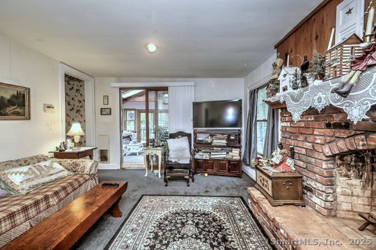 161 Jockey Hollow Road Monroe, CT 06468 - Photo 20 of 37 a living room with furniture and a flat screen tv