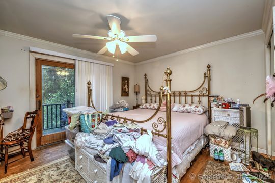 161 Jockey Hollow Road Monroe, CT 06468 - Photo 27 of 37 a bedroom with furniture and a chandelier