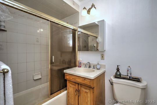 161 Jockey Hollow Road Monroe, CT 06468 - Photo 35 of 37 a bathroom with a sink and mirror with bathtub