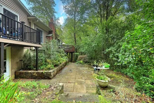 a view of a chair and table in backyard of the house
