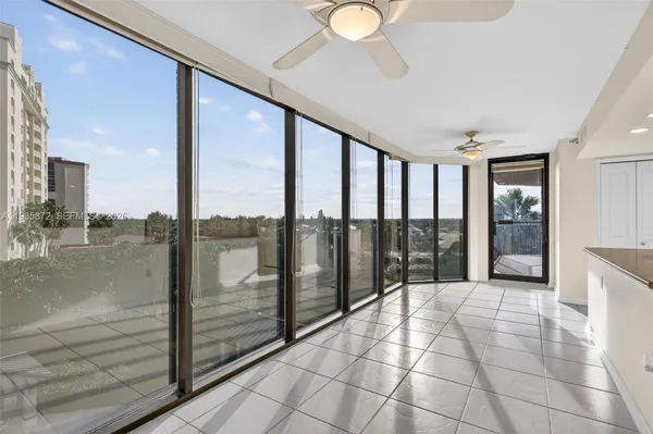 a large white kitchen with a large window