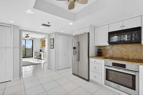a view of a kitchen with granite countertop cabinets