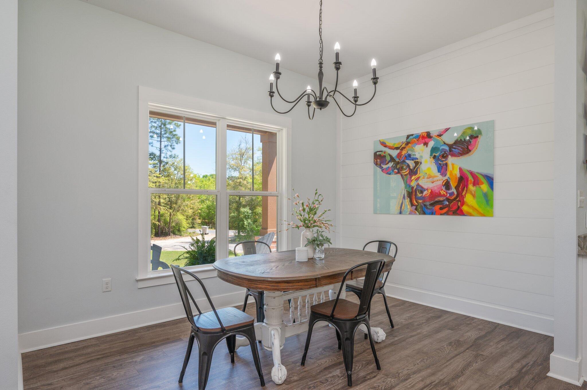 5732 Griffith Cemetery Road Baker, FL 32531 - Photo 8 of 60 a view of a dining room with furniture a chandelier and wooden floor